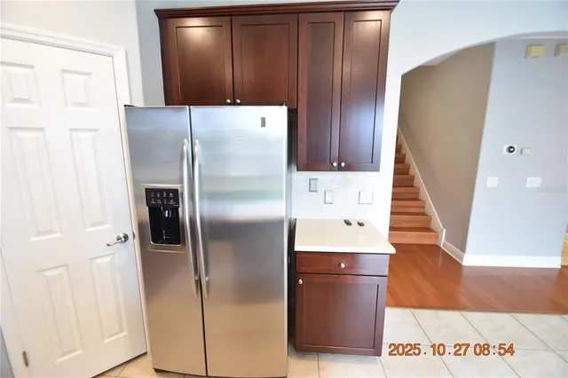 a kitchen with a refrigerator and cabinets