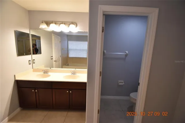 a bathroom with a sink vanity and a mirror