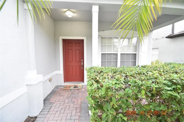 an empty room with wooden floor cabinet and windows