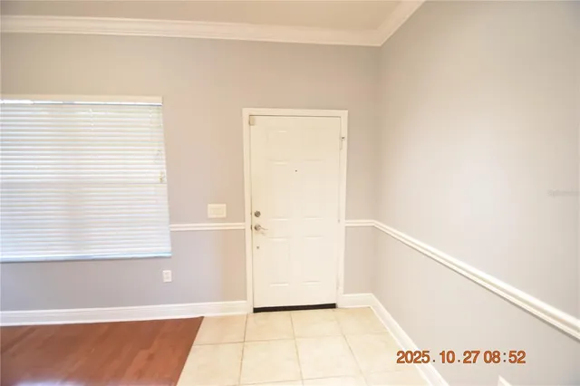 a view of a hallway with wooden floor staircase and a chandelier