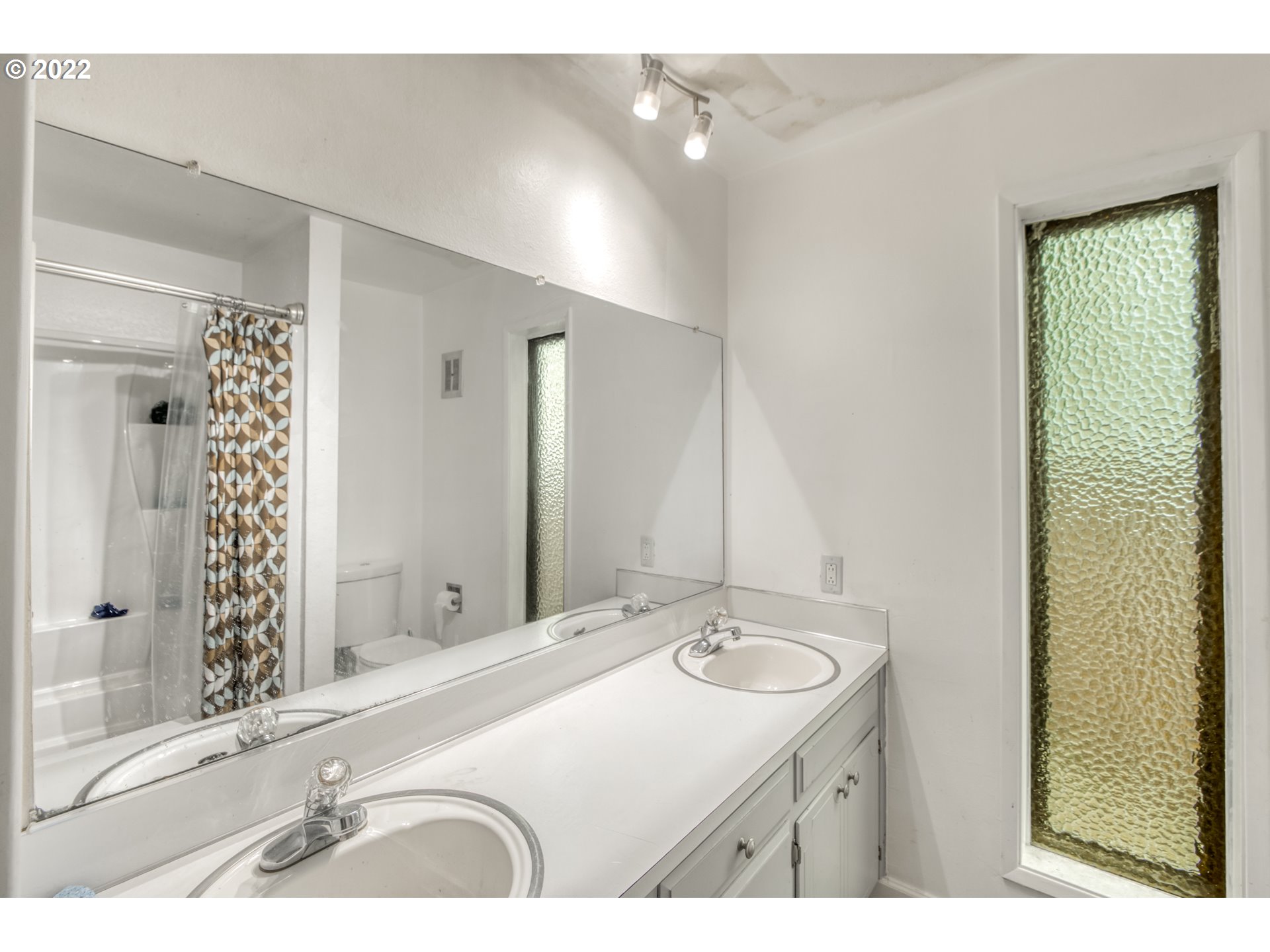 8960 Southwest Cashmur Lane Portland, OR 97225 - Photo 11 of 19 a bathroom with a double vanity sink mirror and shower