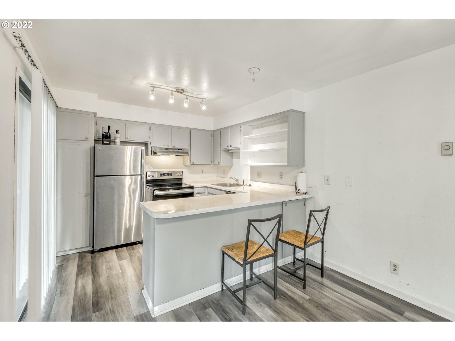 8960 Southwest Cashmur Lane Portland, OR 97225 - Photo 5 of 19 a kitchen with stainless steel appliances a refrigerator and a stove