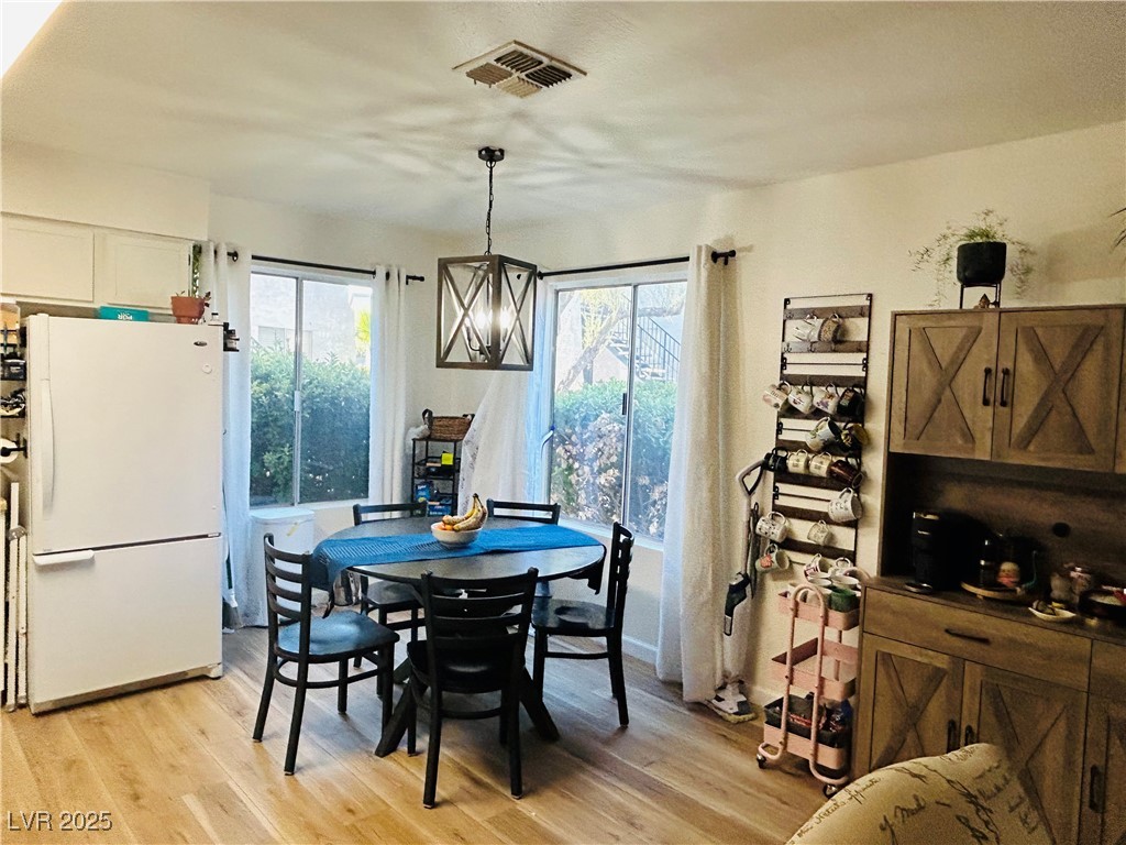 524 Fir Street, Unit 203 Boulder City, NV 89005 - Photo 4 of 7 This cozy breakfast nook is bathed in natural light from large windows, creating a welcoming spot for morning meals. The open layout enhances the airy and inviting atmosphere, perfect for casual dining.