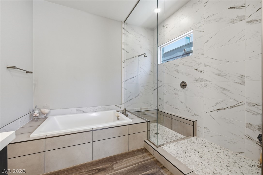 4246 Swift Street Las Vegas, NV 89135 - Photo 41 of 71 Full bath with a marble finish shower, dark wood finished floors, and a garden tub