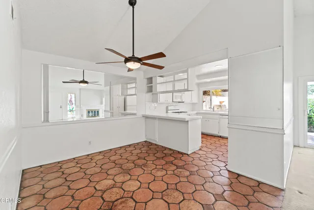 a kitchen with stainless steel appliances kitchen island granite countertop a sink cabinets and window