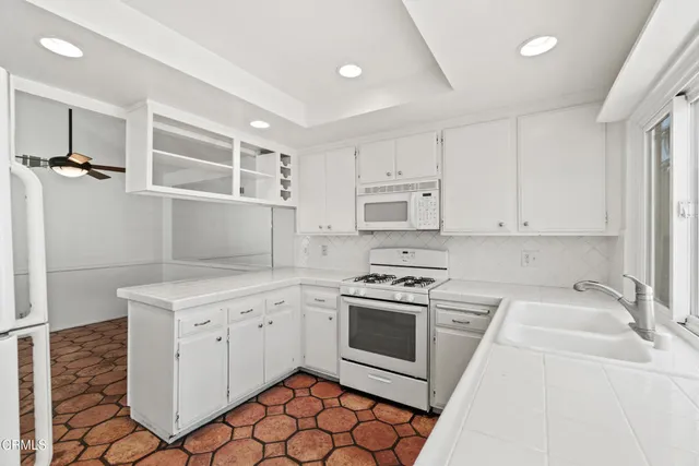 a kitchen with cabinets appliances and a sink