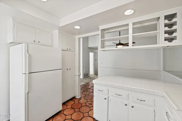 a kitchen with cabinets and white appliances