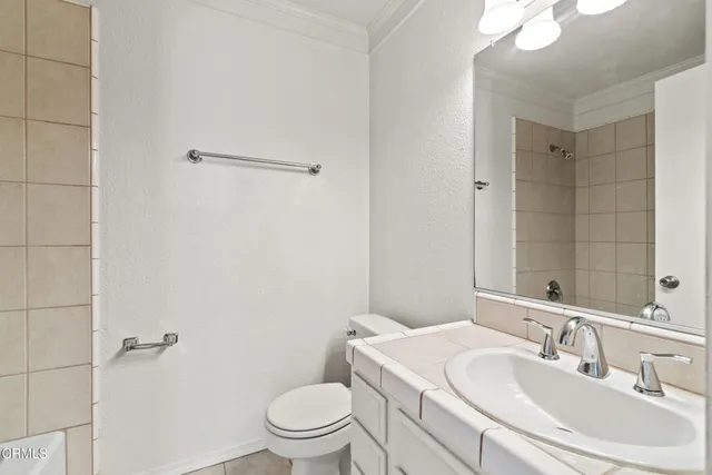 a bathroom with a sink toilet and vanity