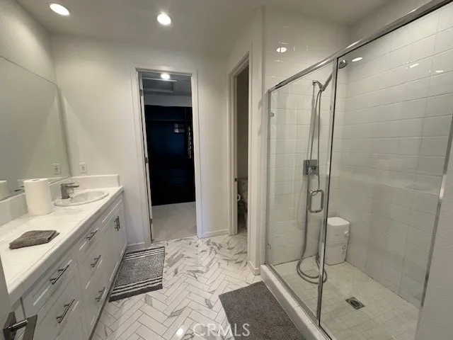 a bathroom with a double vanity sink toilet and shower
