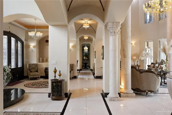 a view of a hallway with living room and couches