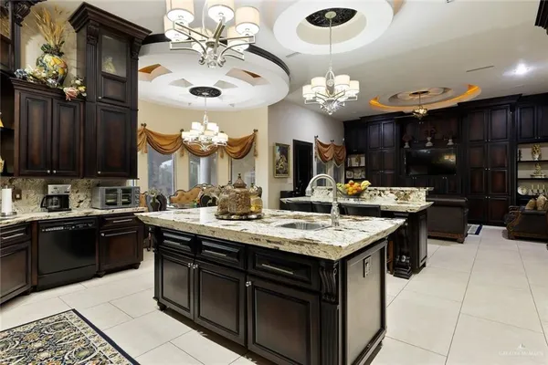 a kitchen with a counter space a sink and cabinets