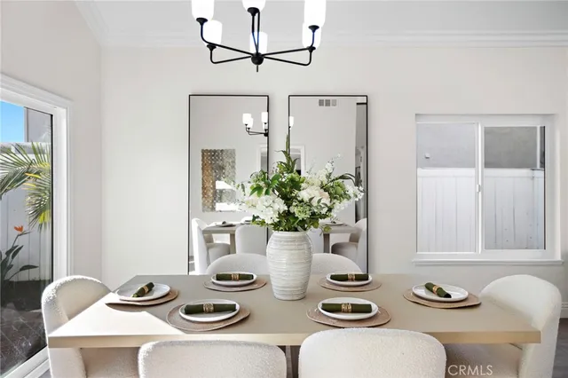 a view of a dining room with furniture and a potted plant