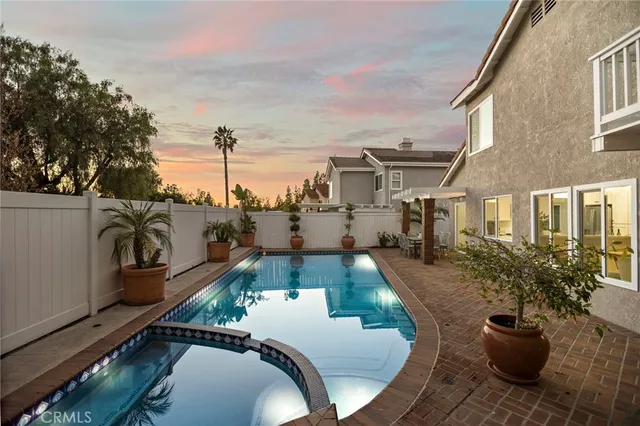 a swimming pool view with a outdoor seating