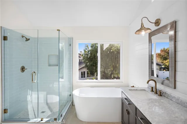 a bathroom with a granite countertop sink toilet and mirror