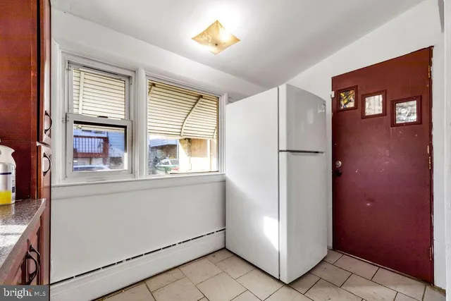 a kitchen with a refrigerator and a cabinets