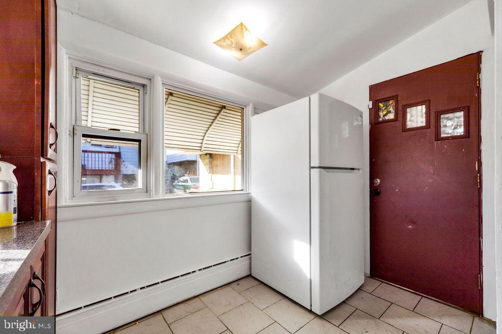212 Heather Road Upper Darby, PA 19082 - Photo 14 of 28 a kitchen with a refrigerator and a cabinets