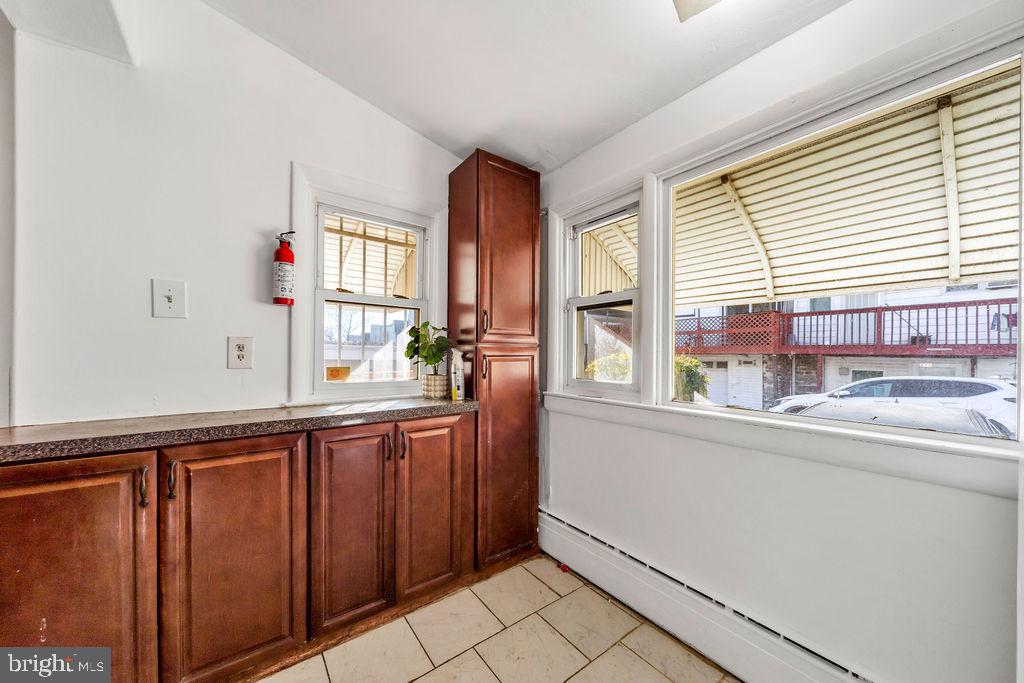 212 Heather Road Upper Darby, PA 19082 - Photo 15 of 28 a kitchen with granite countertop a sink and a window
