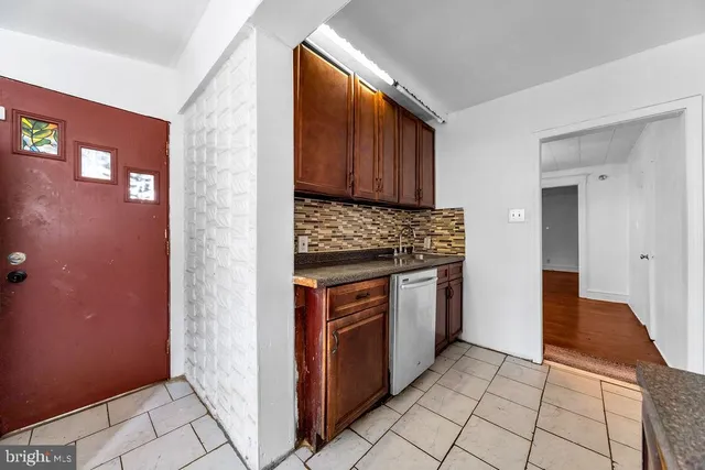 a kitchen with stainless steel appliances granite countertop a stove a refrigerator and a cabinets