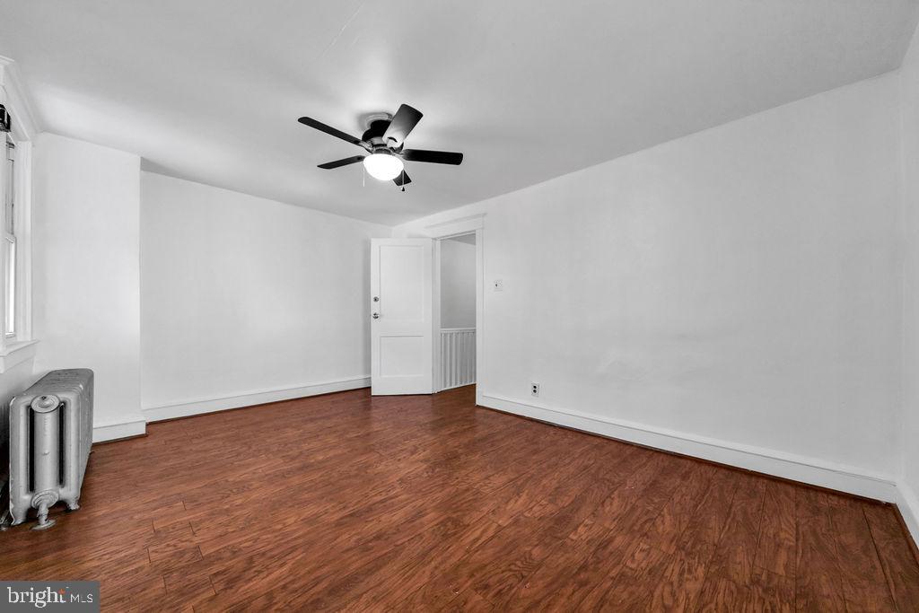 212 Heather Road Upper Darby, PA 19082 - Photo 18 of 28 an empty room with wooden floor and windows