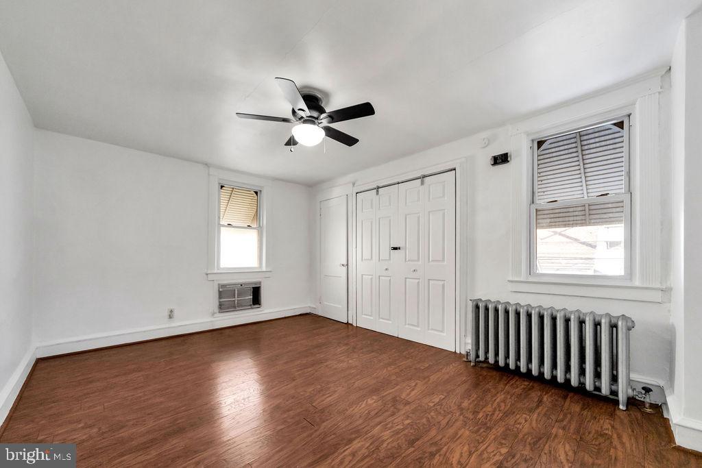212 Heather Road Upper Darby, PA 19082 - Photo 19 of 28 a view of empty room with wooden floor and fan