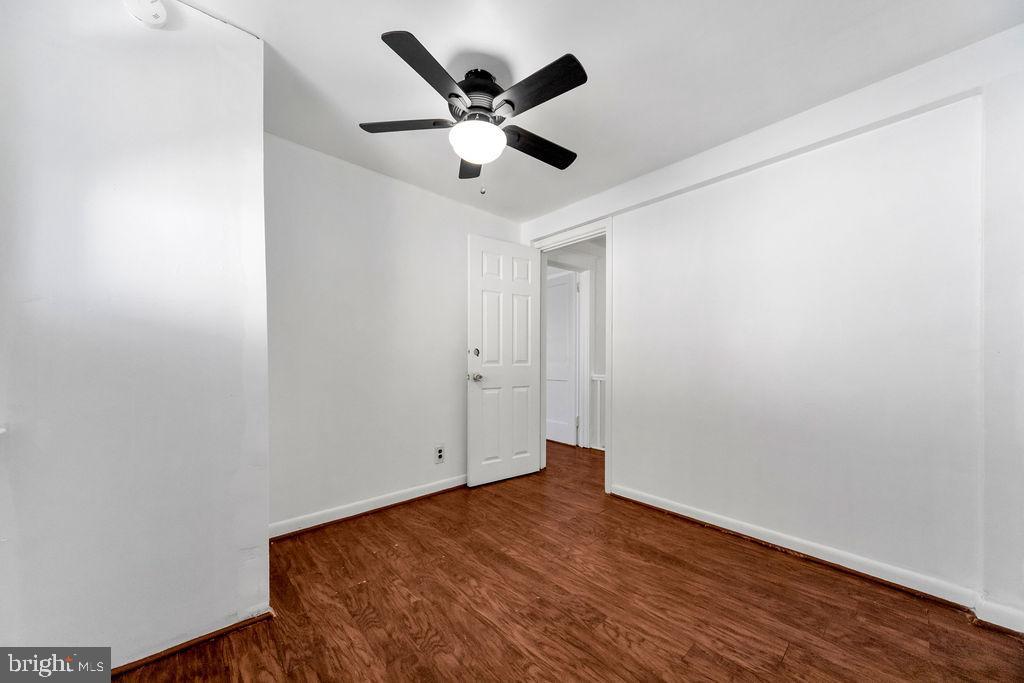 212 Heather Road Upper Darby, PA 19082 - Photo 21 of 28 an empty room with wooden floor ceiling fan and window