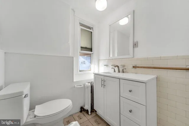 a bathroom with a sink a toilet and vanity