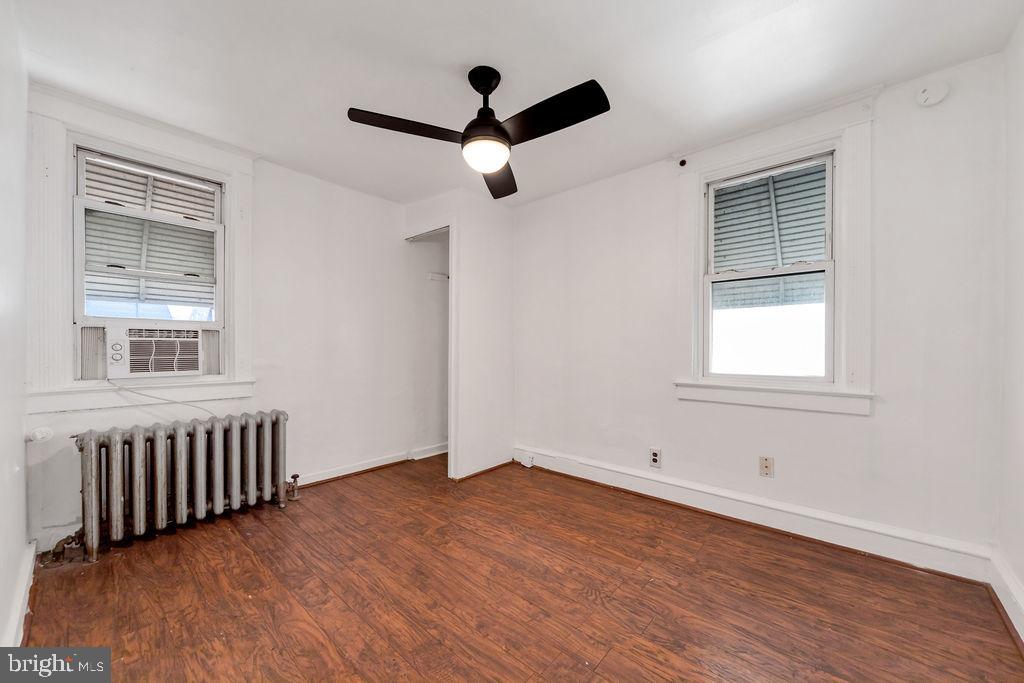 212 Heather Road Upper Darby, PA 19082 - Photo 24 of 28 a view of an empty room with wooden floor and a window