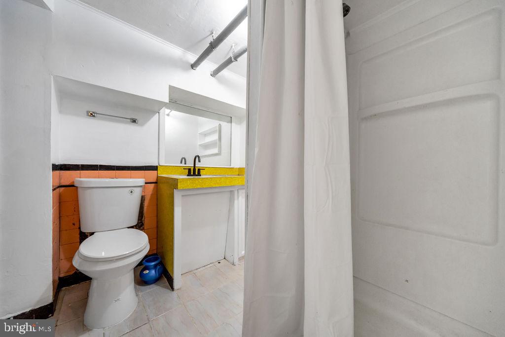 212 Heather Road Upper Darby, PA 19082 - Photo 27 of 28 a white toilet sitting next to a shower