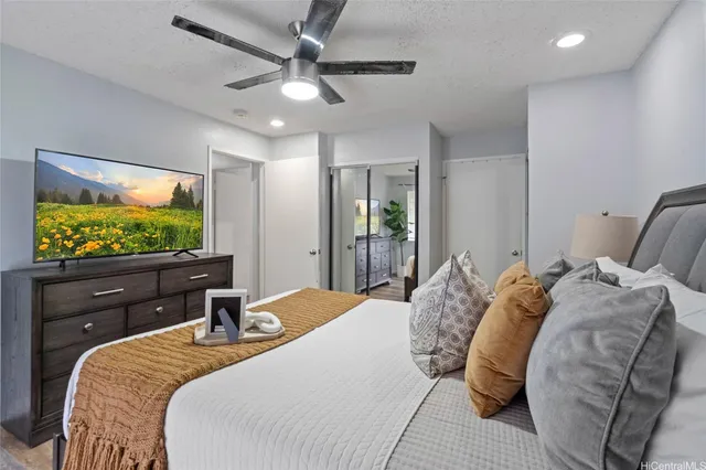 a bedroom with a bed and a flat screen tv