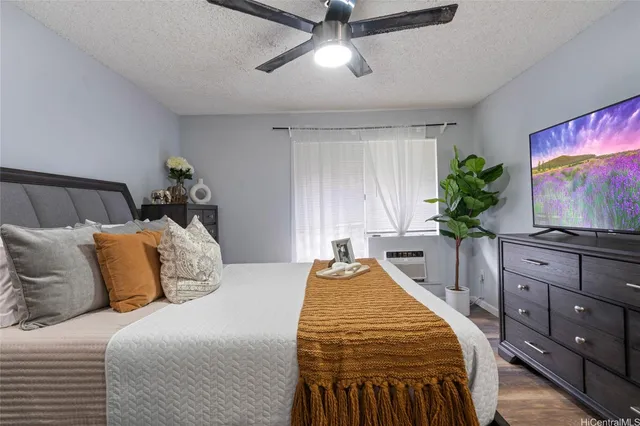 a bedroom with a bed and a flat screen tv