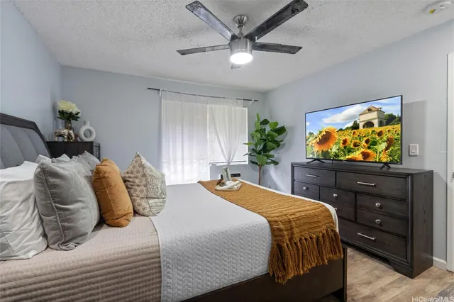 a bedroom with a bed and a flat screen tv