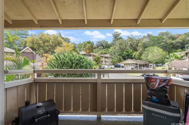 a view of a balcony with chair and table