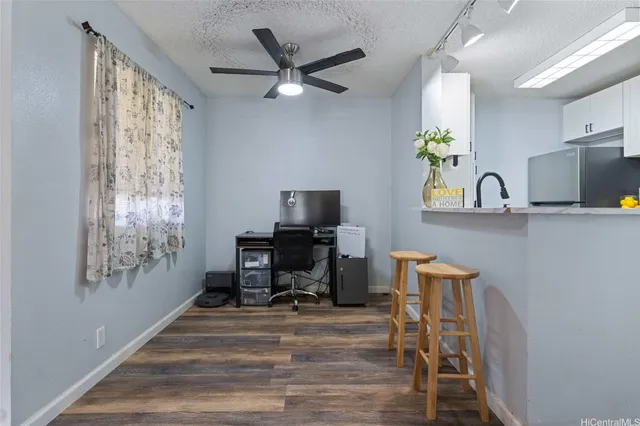a view of a workspace with furniture and a window