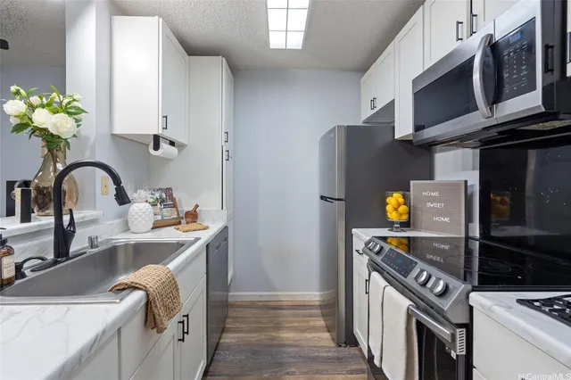 a kitchen with a sink appliances and cabinets