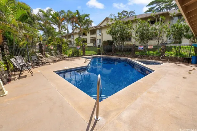 a swimming pool with outdoor seating and yard