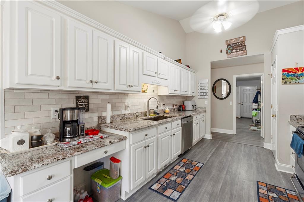 3724 Lexington Court Gainesville, GA 30504 - Photo 15 of 56 a kitchen with granite countertop a sink a stove a refrigerator and cabinets