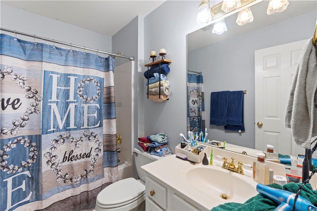 3724 Lexington Court Gainesville, GA 30504 - Photo 27 of 56 a bathroom with a sink vanity mirror and toilet