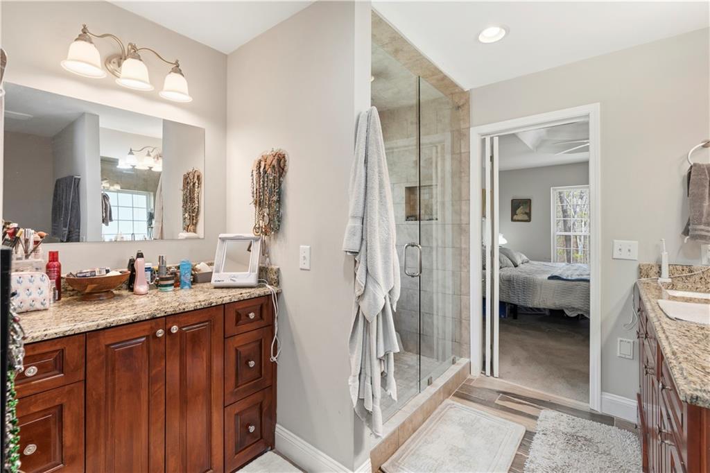 3724 Lexington Court Gainesville, GA 30504 - Photo 32 of 56 a en suite bathroom with a granite countertop sink mirror and a shower