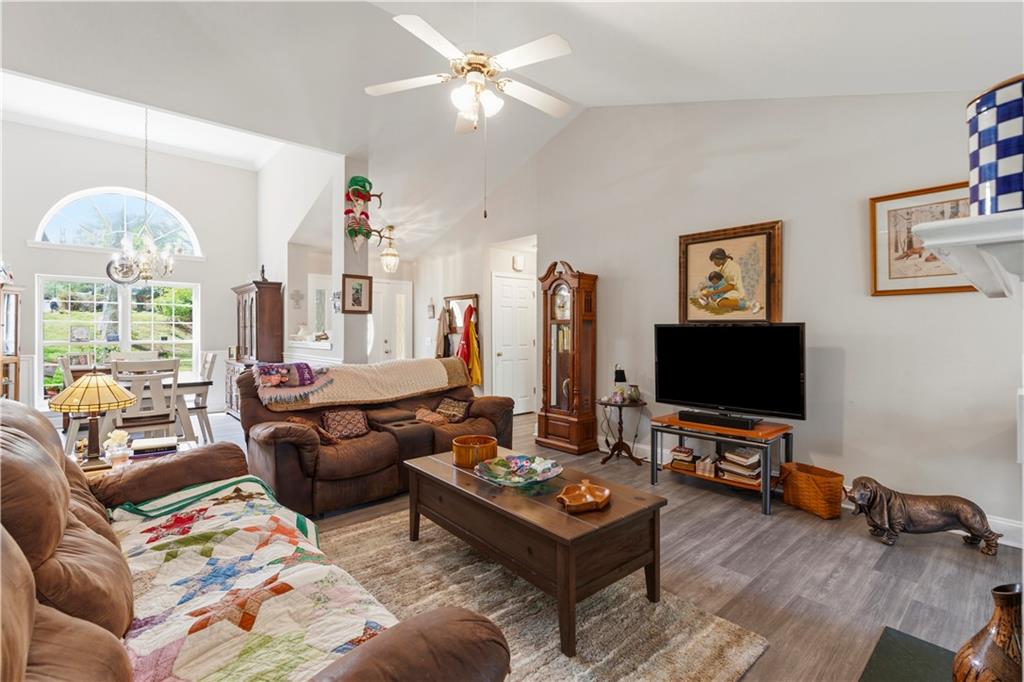 3724 Lexington Court Gainesville, GA 30504 - Photo 7 of 56 a living room with furniture a chandelier and a flat screen tv