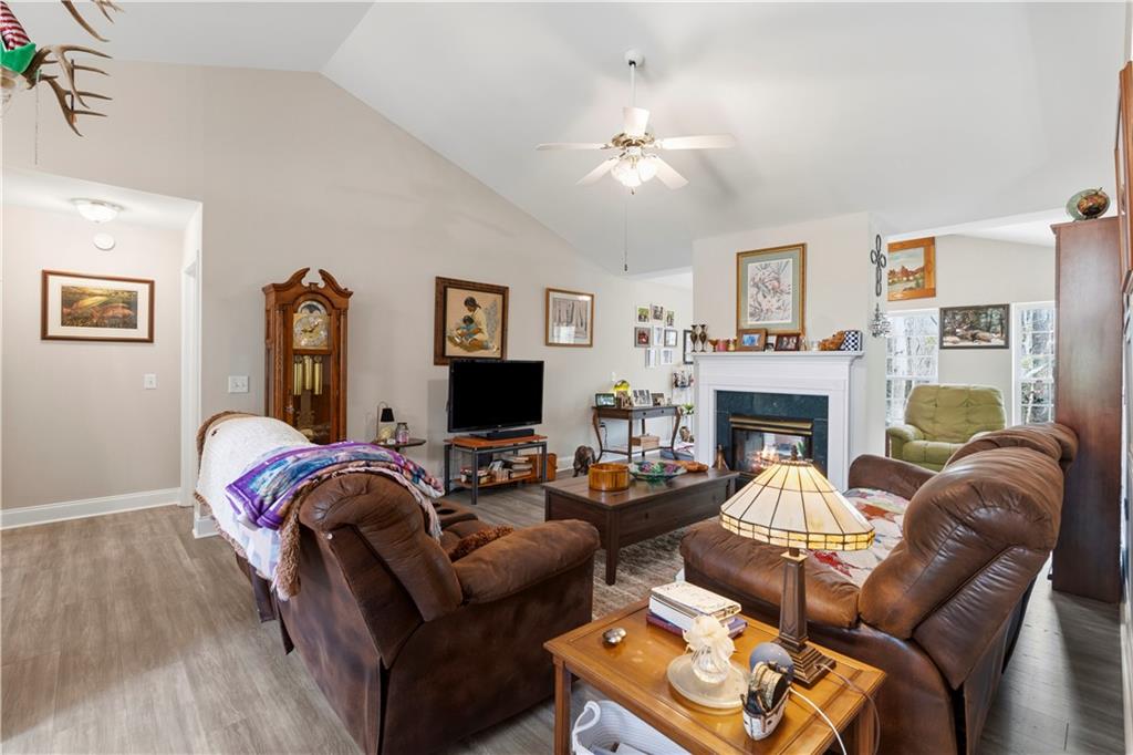 3724 Lexington Court Gainesville, GA 30504 - Photo 8 of 56 a living room with furniture a fireplace and a flat screen tv