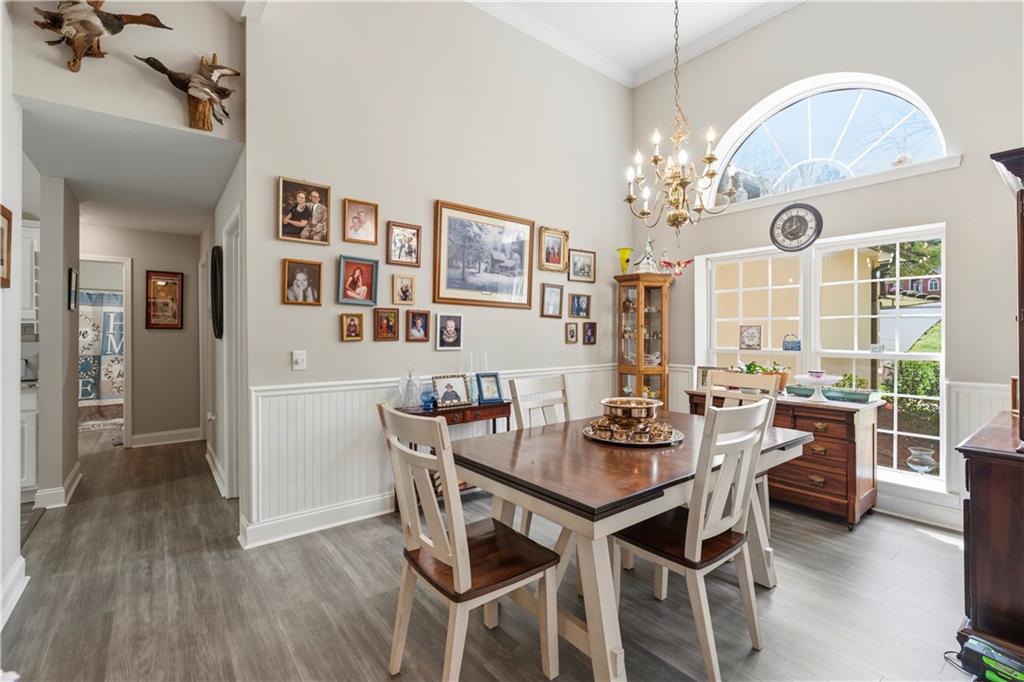 3724 Lexington Court Gainesville, GA 30504 - Photo 10 of 56 a view of a dining room with furniture a chandelier and wooden floor