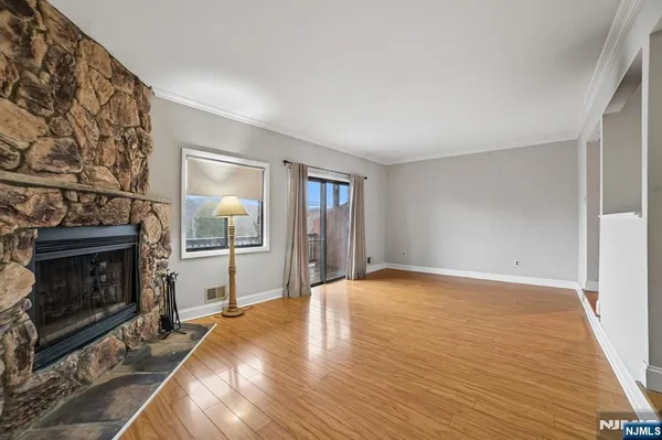 a view of an empty room with window and fire place
