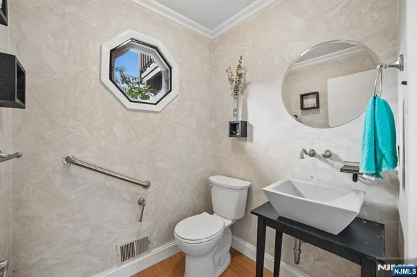 a bathroom with a toilet a sink and a mirror