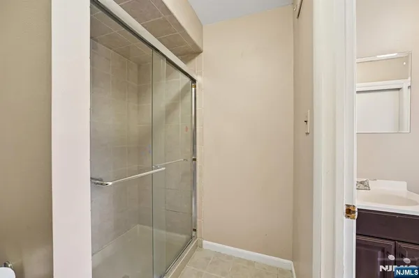 a bathroom with a shower and a sink