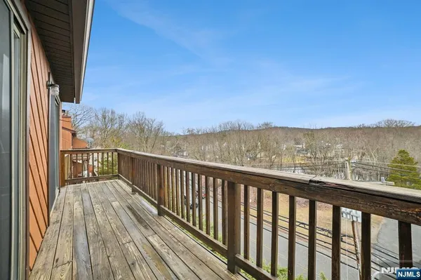 a view of balcony with wooden floor and fence