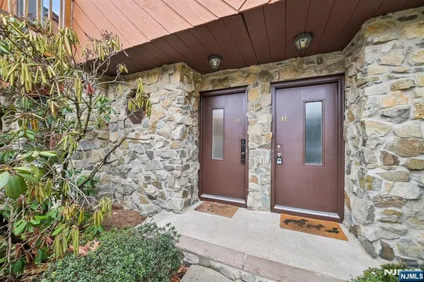 a view of a wooden door and brick wall