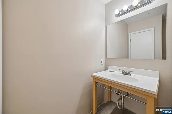 a bathroom with a sink a vanity and a mirror