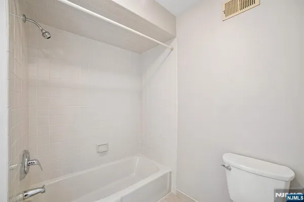 a white bath tub sitting next to a white toilet