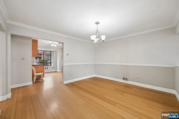 a view of empty room with wooden floor and fireplace