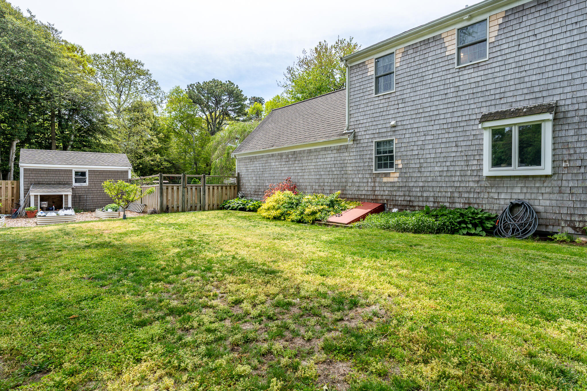 61 Angus Way Centerville, MA 02632 - Photo 48 of 59 a backyard of a house with table and chairs